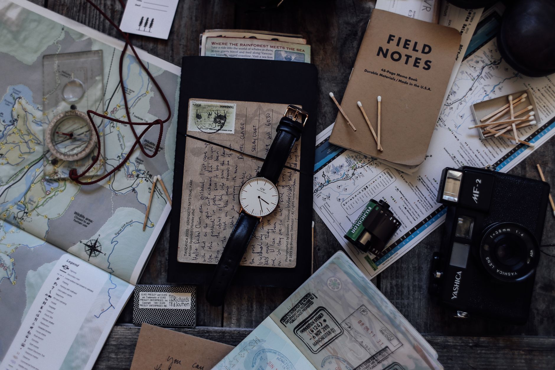 Custom itinerary notebook and map on wooden table